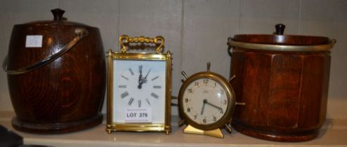 Two oak cased biscuit barrels and two brass cased mantel clocks