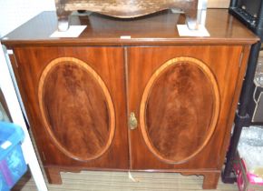 A part 19th century oval panelled two-door cupboard