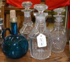 Three Regency period mallet shaped decanters, with mushroom stoppers, together with an early Victori