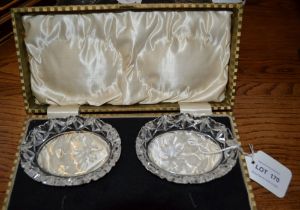 A pair of boxed glass dishes with thistle intaglio decoration