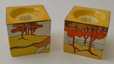 A pair of Clarice Cliff Coral Firs pattern hand painted pottery cube form candle holders, pattern nu