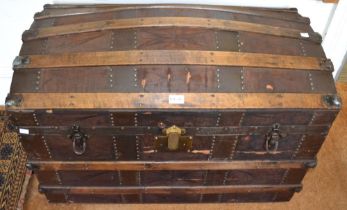 A wooden banded dome top travel trunk, with carrying handles