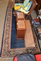 Early 20th century woven woollen long rug of blue ground and floral boarder