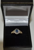 A sapphire and diamond ring, set in a 9ct gold band, ring size M