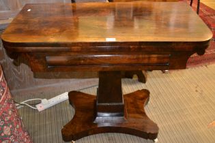 A 19th century rosewood fold over tea table, tapering column and plinth base