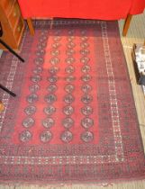 Red ground woollen floor carpet many central small 'elephants' feet multi guard boarders