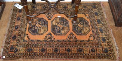 An Afghan Turkoman small rug three central guls within multi guard boarders