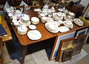 Edwardian mahogany wind out dining table with central leaf and winder