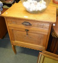 A continental oak side cabinet with single drawer over fall front