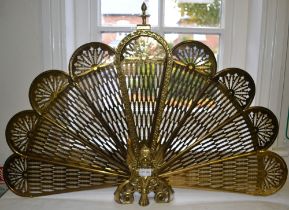 A decorative folding brass spark guard