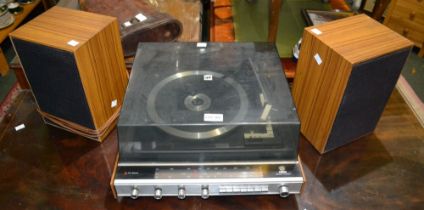 A vintage Ultra-Group stereo with speakers