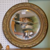 A bevel edged brass framed circular mirror