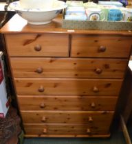 A modern pine seven drawer chest