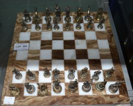 A marble chess board with cast metal chess men