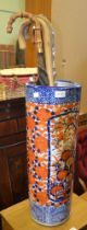 An Imari design pottery cylindrical stick stand, with various sticks