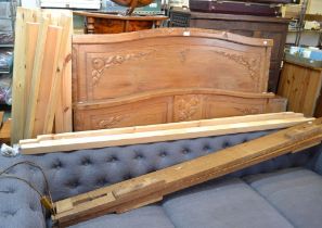 A carved oak head and foot board with side rails slats etc