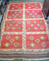 A red ground large geometric large rug, 186cm x 280cm