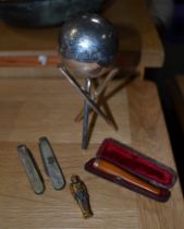 A silver ball on stand, amber holder, etc