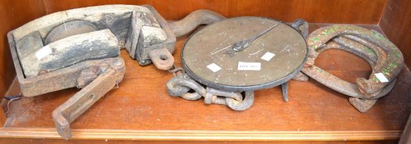 A vintage wood and metal hanging winch with horseshoes brass scale etc