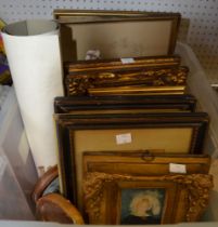 A crate containing a selection of pictures and prints