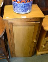 A pine single door bedside cupboard