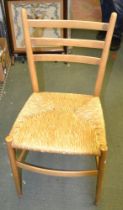 A suite of eight modern beech ladder back chairs with rush seats