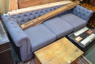 A modern three seater Chesterfield style grey settee
