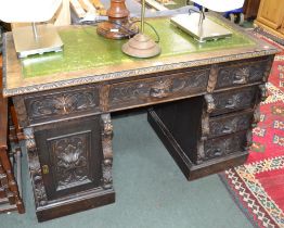 A 19th century carved oak Green Man twin pedestal desk, 122cm x 76cm x 60cm