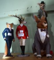 A group of animal figurines in formal dress