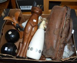 A box containing a wooden cat, two vintage bowling balls, African carving etc