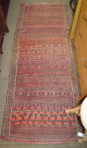 A Middle Eastern banded rug, bordered & fringed to one end, 230cm x 90cm