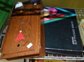 A set of snooker balls in their own oak case, the sliding cover inlaid with the table format
