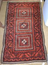 A belouch design rug, three geometric field, red ground, fringed & bordered