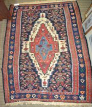 A Senna or Kelim rug, stylized lozenge design on a blue field, fringed & bordered, probably from Aze