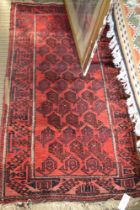 A red ground Turkoman rug, fringed & bordered, 150cm x 81cm