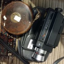A vintage Bell and Howell cine camera plus a vintage Chesterman measuring tape
