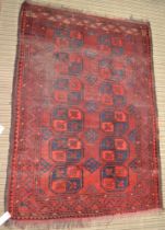 A red ground Turkoman rug, fringed & bordered, 144cm x 100cm
