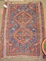 A Persian design rug with geometric form, on terracotta ground, fringed & bordered, 120cm x 85cm