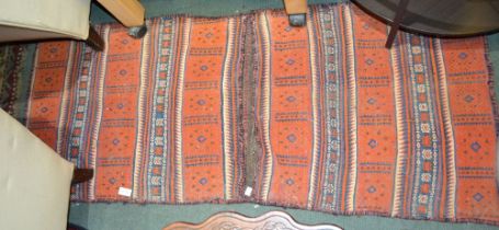 A pair of orange ground banded design fully backed saddle bags