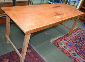 A wooden vintage folding trestle table