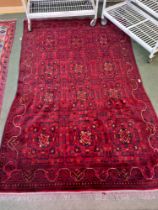 A room sized dark red ground woven woollen modern floor carpet 168 x 243 cm