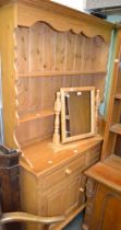 A large pine dresser, two drawers over two cupboard doors and a two shelf unit