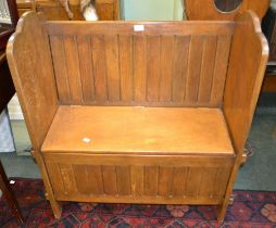 A pegged oak hall settle with storage seat