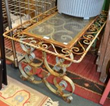 A wrought iron outdoor table with glass inset