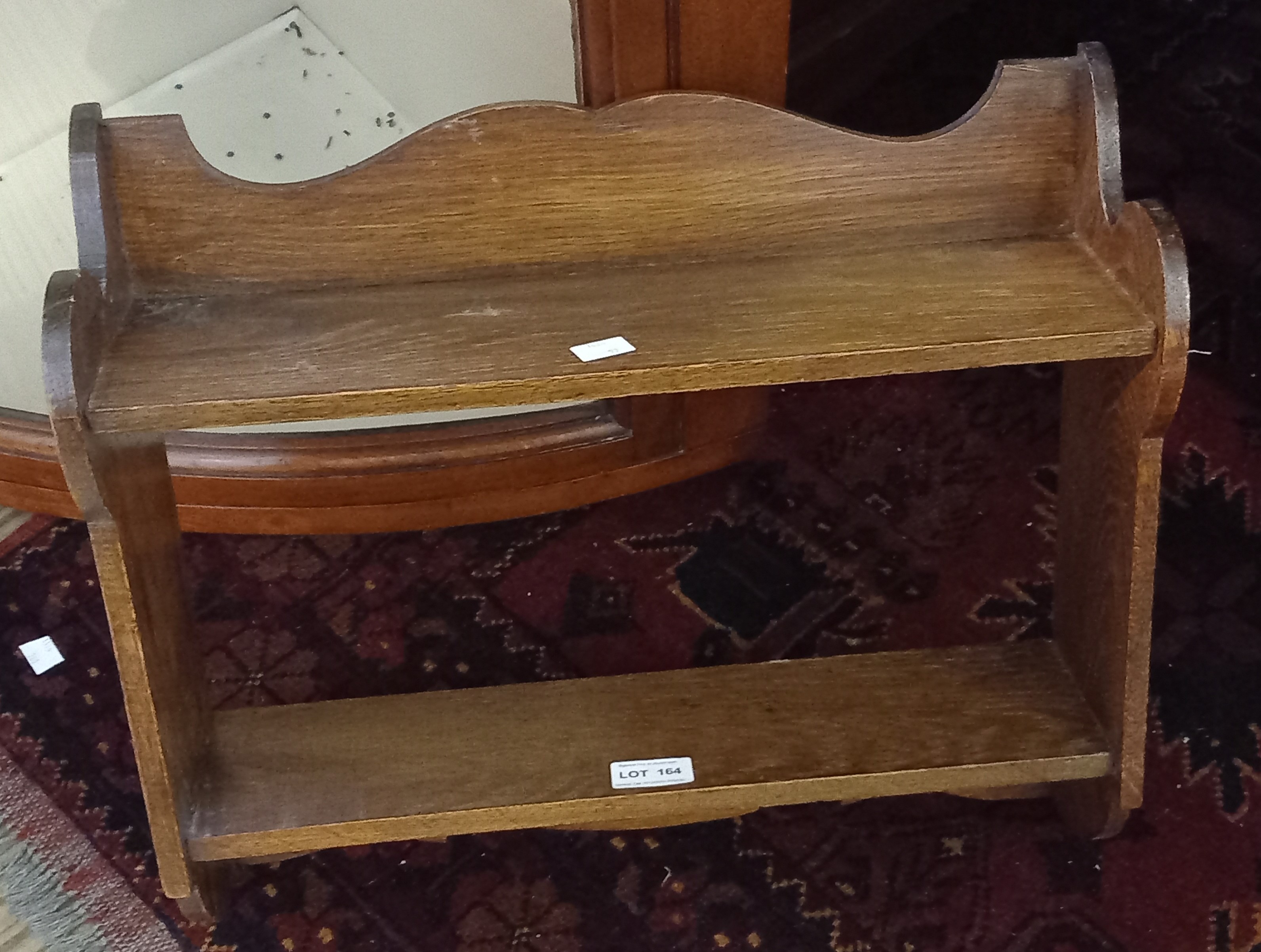 A small oak wall hanging set of shelves