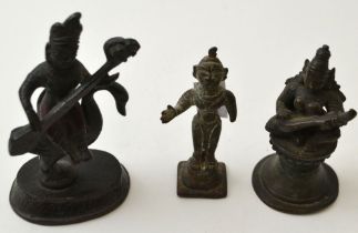 Two cast bronze Far Eastern musician figures, on raised bases, the tallest seated upon a swan, 10cm