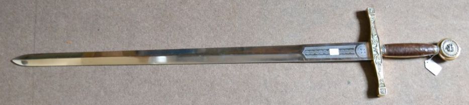 A reproduction of King Arthur's Excalibur sword, with leather grip, and decorative metal fittings, o