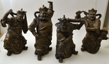 A set of four Chinese ceramic Temple Guardians, each modelled as a fearsome armed figure, tallest 32