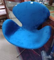 A modern swivel desk chair in Royal Blue upholstery, after the original 'Swan Chair' by Arne Jacobse