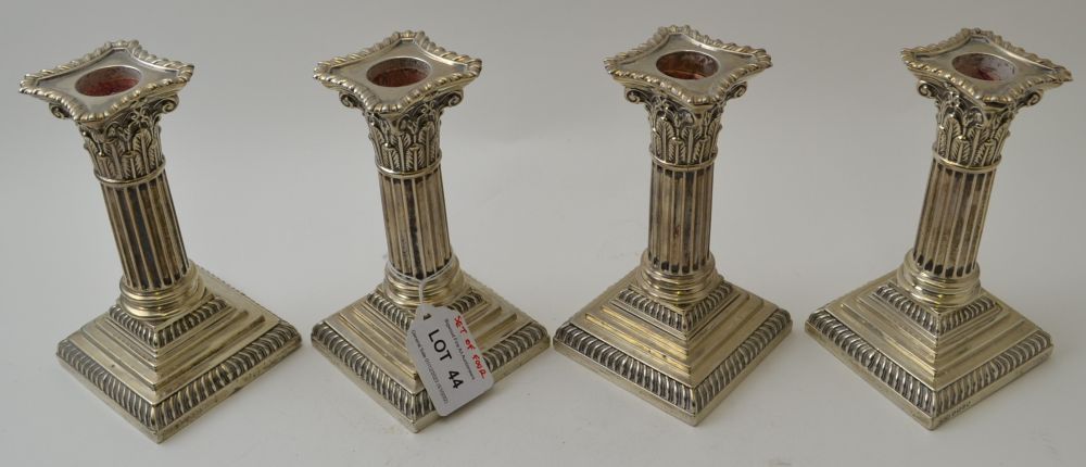 Hawksworth, Eyre & Co. Ltd, a set of four Victorian silver Corinthian column candlesticks, on squar